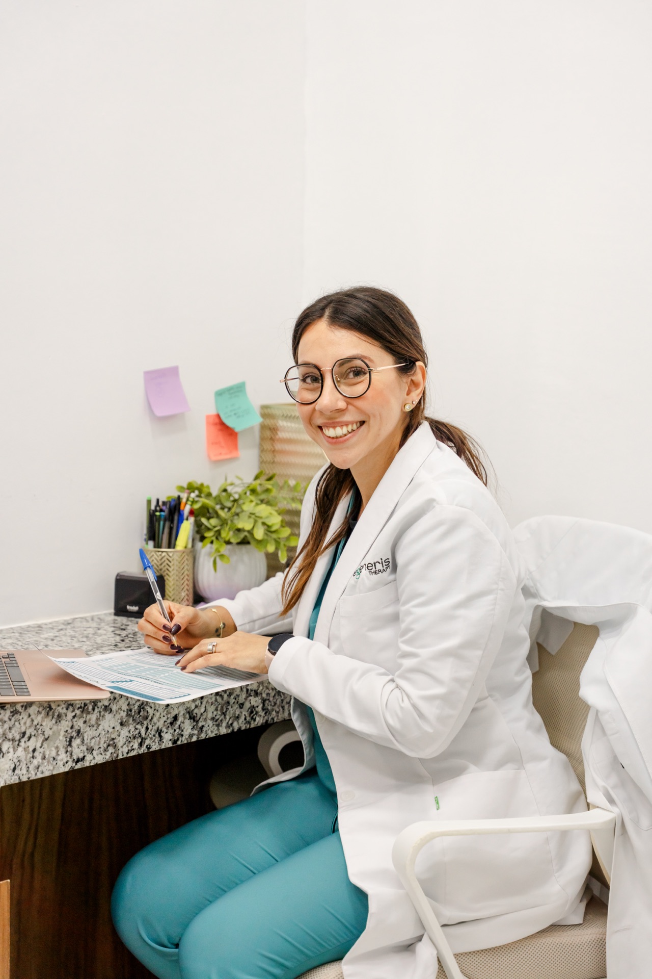 Regeneris doctor smiling at desk during a personalized consultation